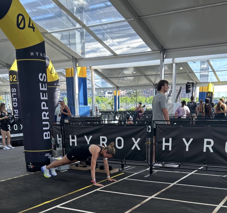 Athlete doing burpee broad jumps at a HYROX race