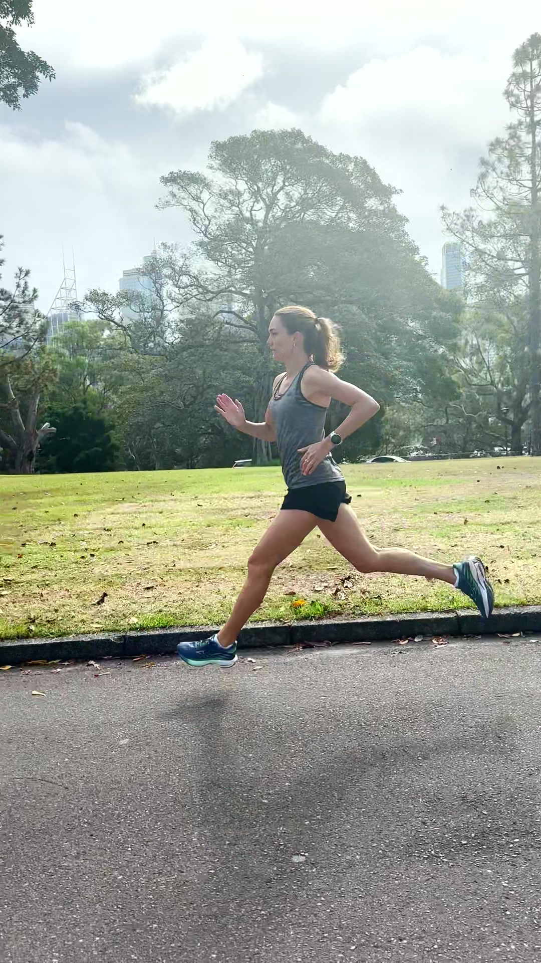 Olivia running through a park